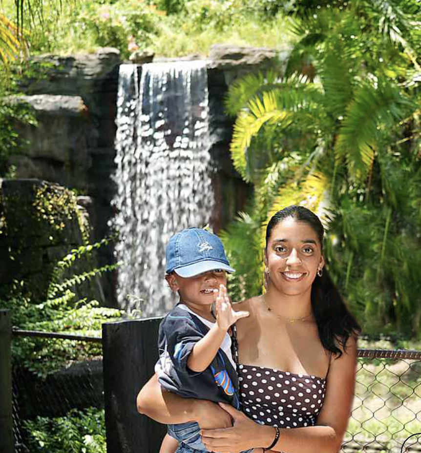 Founder with child at a theme park waterfall